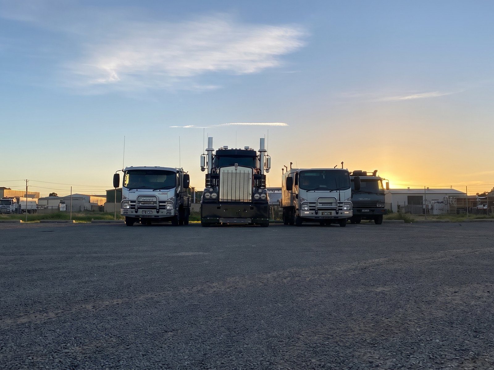 EMTR service trucks lined up at the yard at dusk, Western Sydney