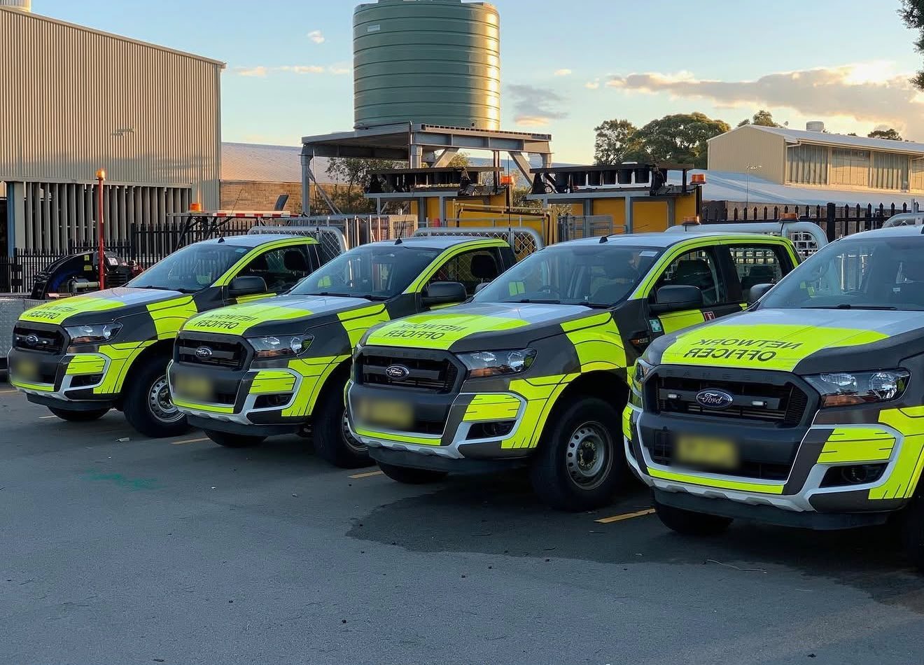 A row of Ford Ranger utes from a light fleet, parked in a depot